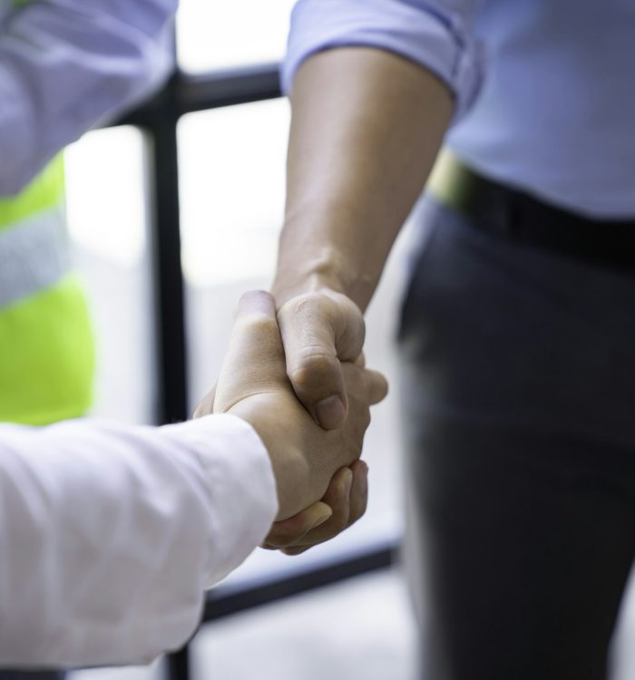 Architect shakes hands at meeting, meeting of two engineers or architects, shaking hands after discu