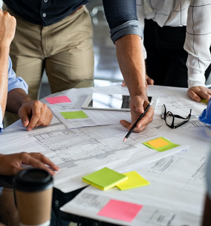 Architects discussing project on blueprint