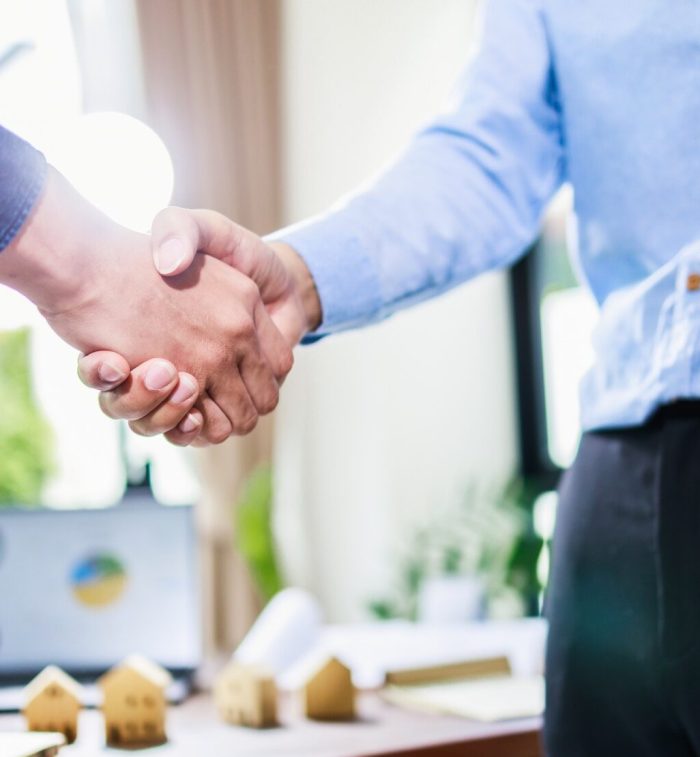 Real estate agent handshake, deal business. Business partnership meeting and home insurance